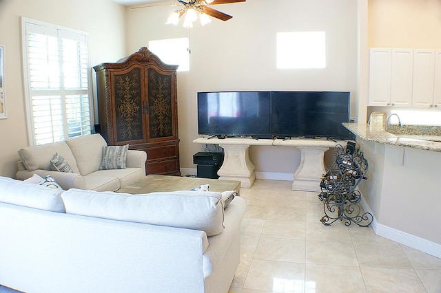 tiled living room with ceiling fan