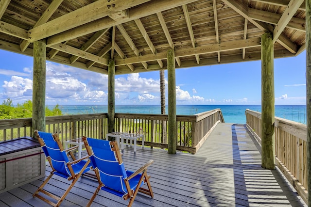 wooden deck with a gazebo and a water view