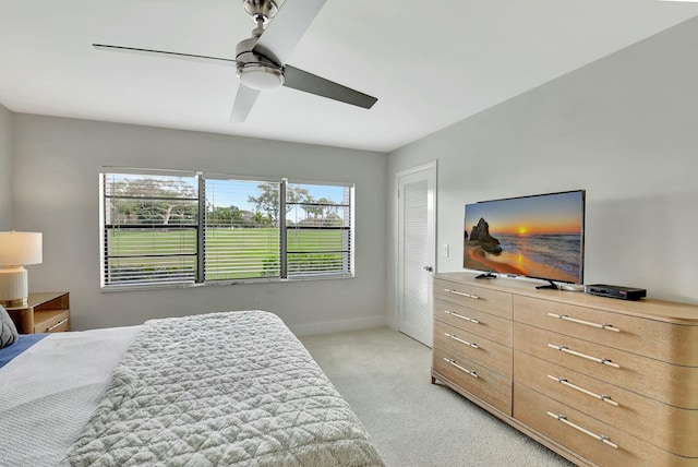 bedroom with light carpet and ceiling fan