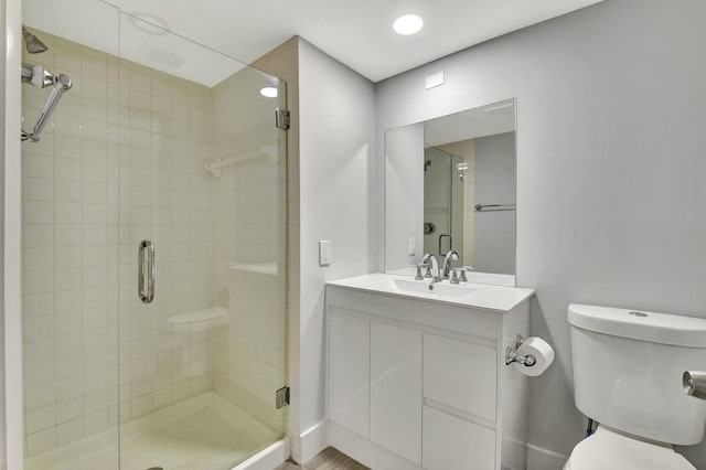 bathroom featuring vanity, toilet, and walk in shower