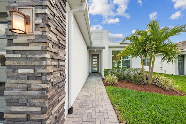 property entrance with stucco siding