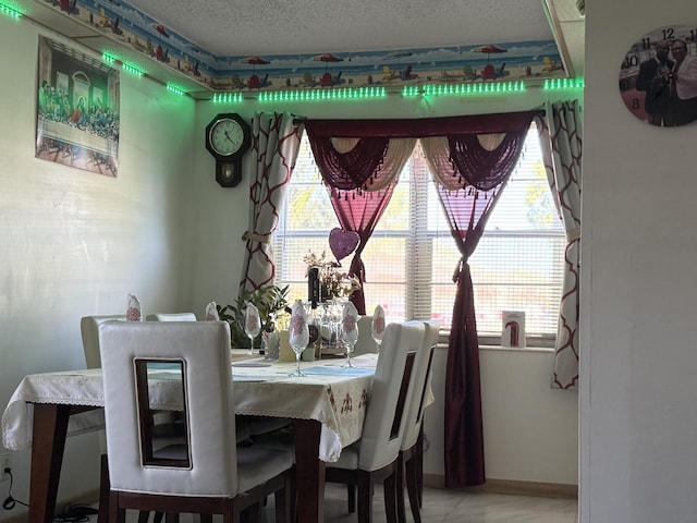 dining space featuring a textured ceiling