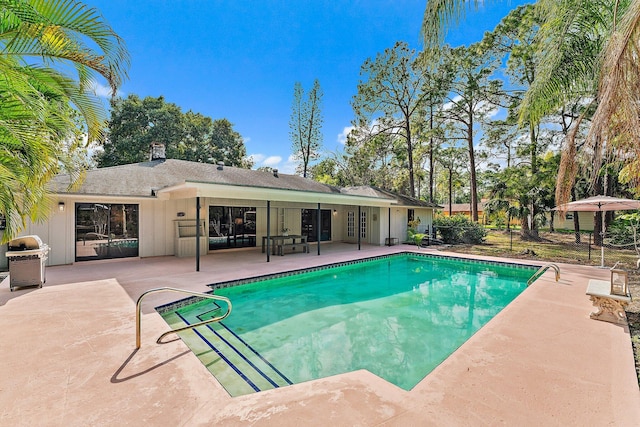 view of pool featuring french doors and a patio area