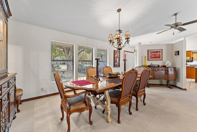 carpeted dining room with lofted ceiling, ceiling fan with notable chandelier, and a textured ceiling