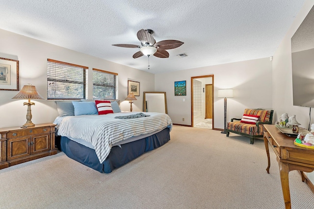 bedroom featuring ceiling fan, light carpet, and a textured ceiling