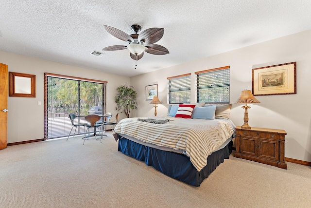 bedroom featuring light carpet, ceiling fan, access to outside, and a textured ceiling