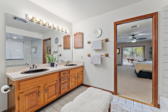 bathroom featuring ceiling fan, tile patterned floors, and vanity