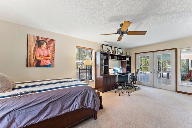 carpeted bedroom featuring ceiling fan and a textured ceiling