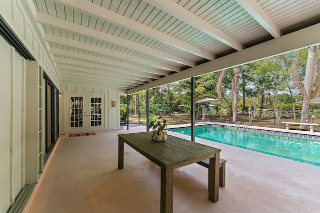 view of swimming pool featuring a patio area and french doors