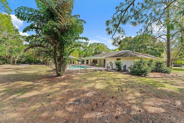 view of yard with a fenced in pool