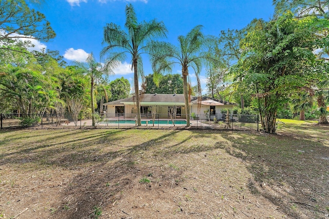 view of yard with a fenced in pool