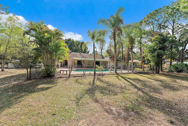 view of yard with a fenced in pool