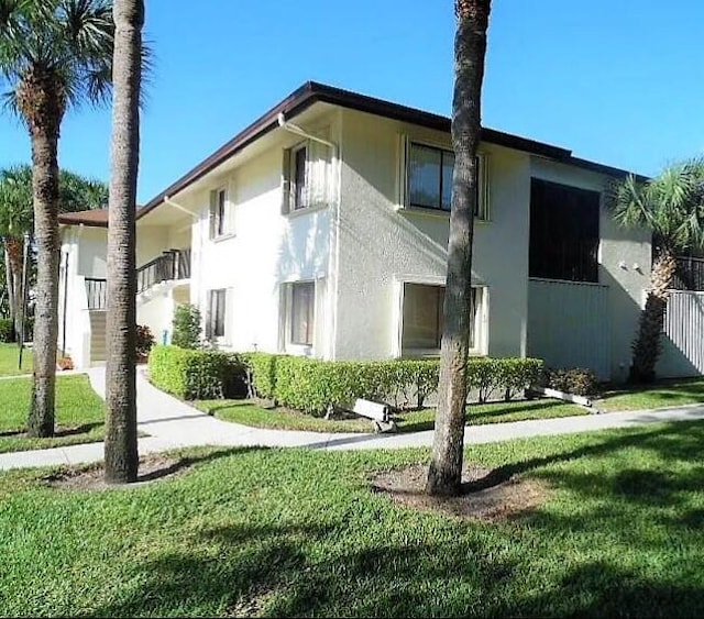 view of property exterior with a lawn