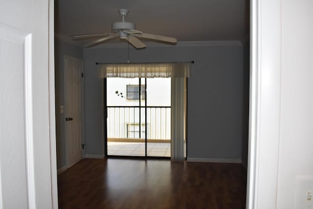 unfurnished room with dark wood-type flooring, ornamental molding, and ceiling fan