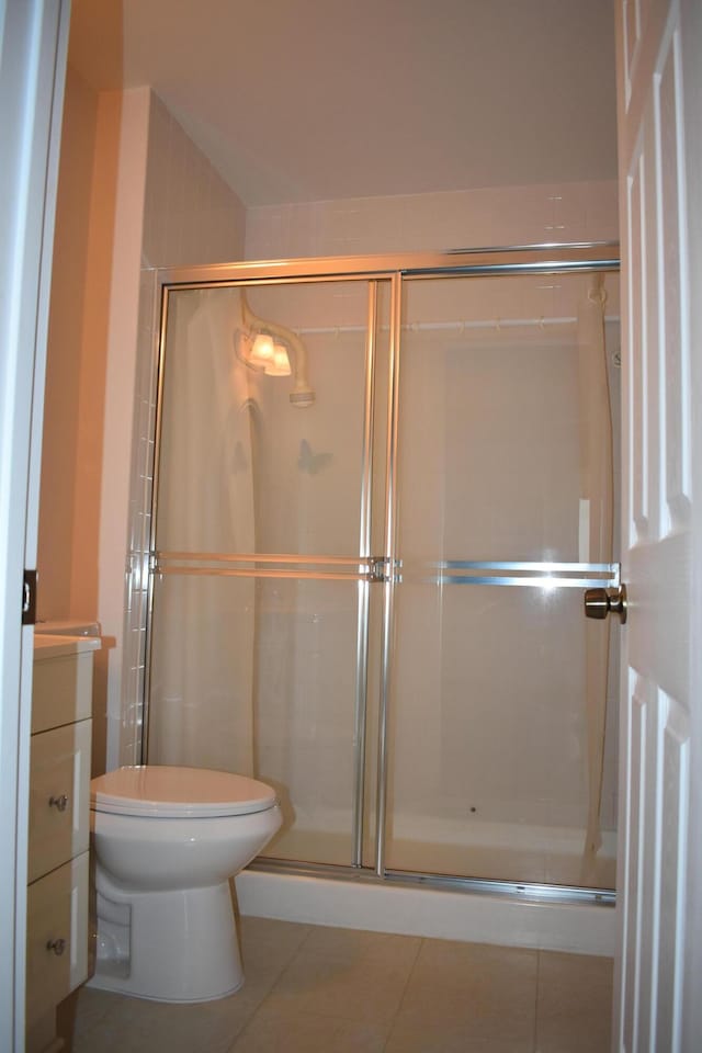 bathroom featuring vanity, an enclosed shower, and tile patterned floors