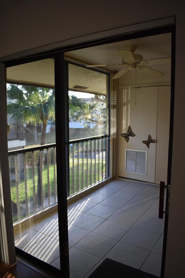 balcony featuring ceiling fan and a water view