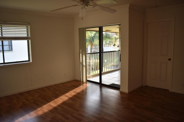 empty room featuring crown molding, ceiling fan, and dark hardwood / wood-style floors