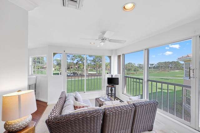 sunroom / solarium featuring plenty of natural light and ceiling fan