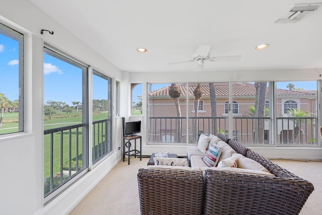 sunroom / solarium featuring ceiling fan