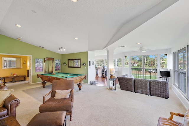 recreation room with lofted ceiling, a textured ceiling, pool table, light colored carpet, and ornate columns