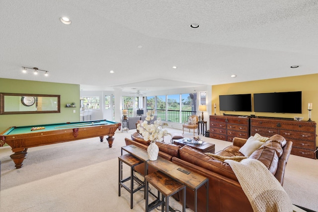 living room featuring lofted ceiling, pool table, light colored carpet, and a textured ceiling