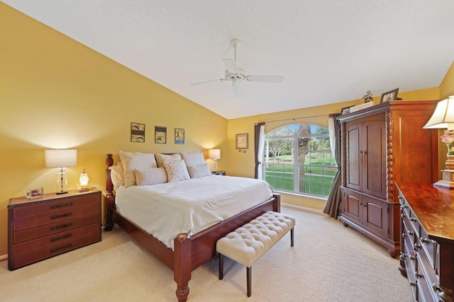 bedroom featuring vaulted ceiling, light carpet, a textured ceiling, and ceiling fan