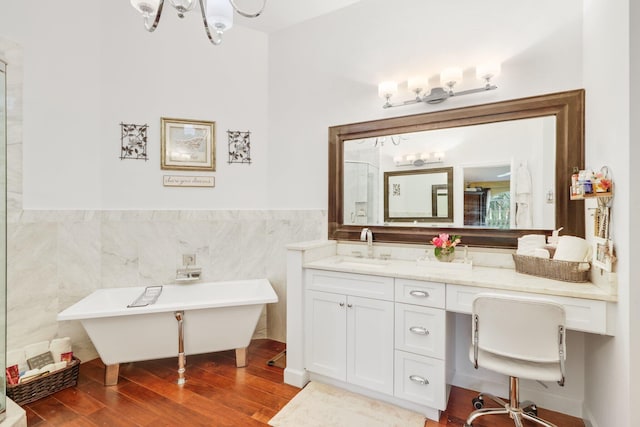 bathroom with a chandelier, tile walls, vanity, independent shower and bath, and hardwood / wood-style floors