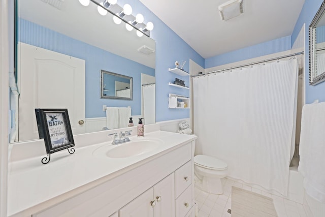 full bathroom with shower / bath combination with curtain, tile patterned floors, vanity, and toilet