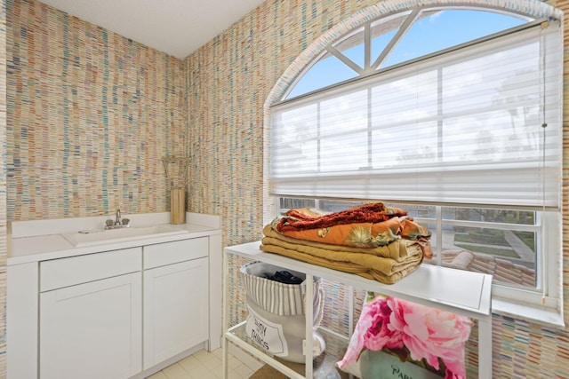 bathroom featuring tile walls, sink, and tile patterned flooring