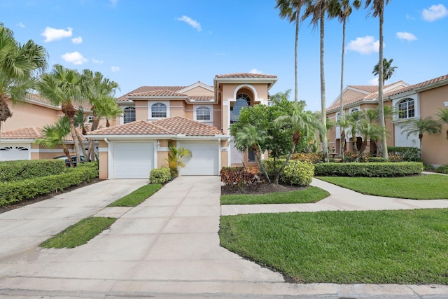 mediterranean / spanish home with a garage and a front lawn