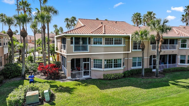 rear view of property featuring a yard