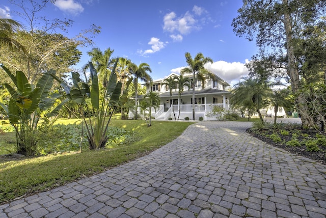 view of front of home with a porch and a front lawn