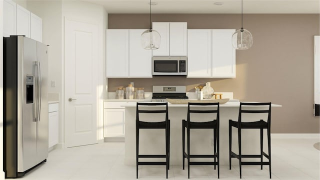 kitchen featuring decorative light fixtures, stainless steel appliances, white cabinets, and a kitchen island