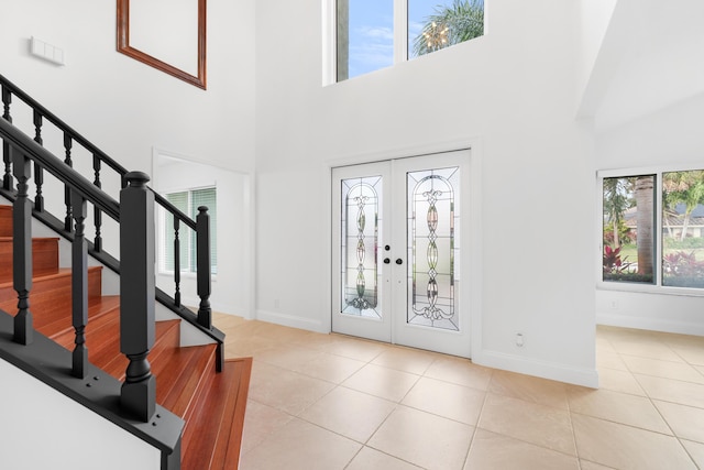 foyer featuring light tile patterned flooring and french doors