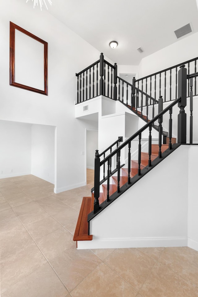 stairway with a towering ceiling