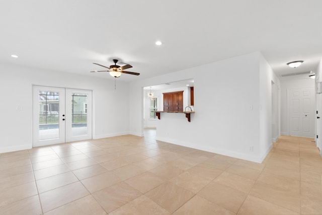 empty room with french doors, ceiling fan, and light tile patterned floors