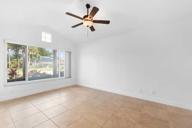 tiled empty room featuring ceiling fan and vaulted ceiling