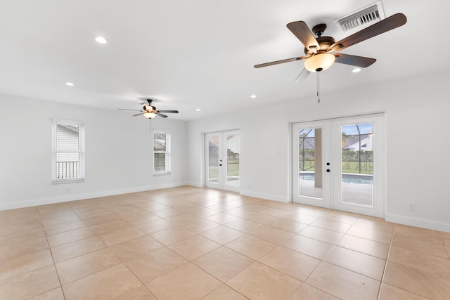 spare room with light tile patterned floors, ceiling fan, and french doors