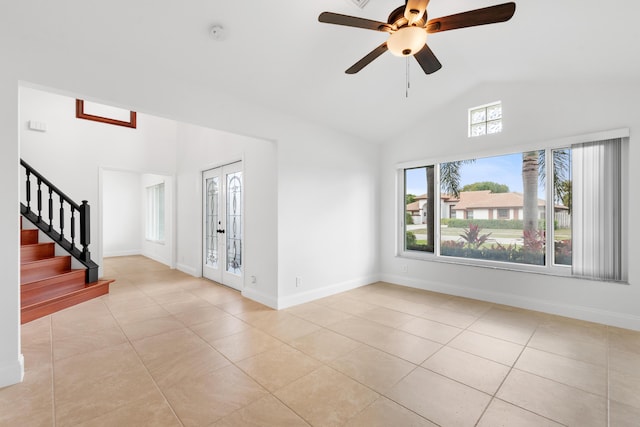 unfurnished living room featuring high vaulted ceiling, french doors, ceiling fan, and light tile patterned flooring