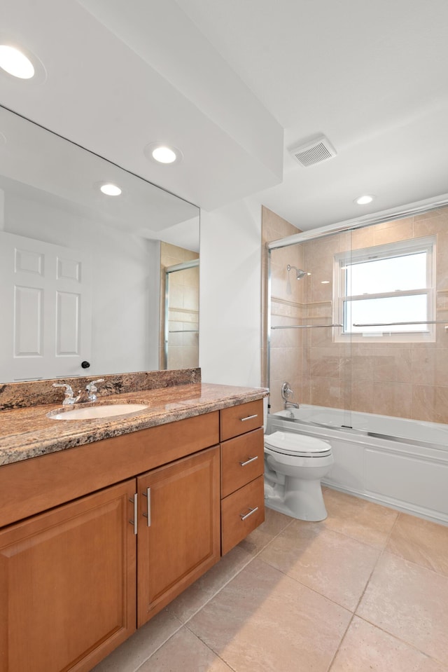 full bathroom featuring enclosed tub / shower combo, vanity, tile patterned floors, and toilet