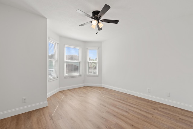 empty room with ceiling fan and light hardwood / wood-style floors