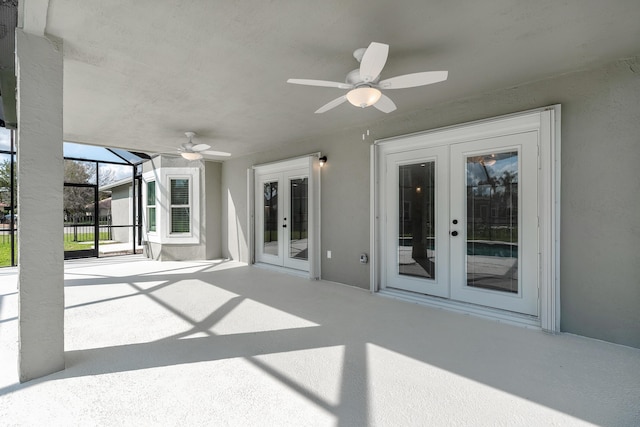 view of patio / terrace featuring french doors, ceiling fan, and glass enclosure