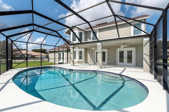 view of swimming pool with a patio area, french doors, ceiling fan, and glass enclosure