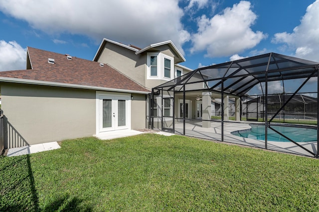 back of house featuring a patio, a lanai, a lawn, and french doors