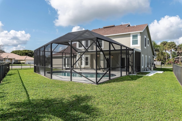 rear view of house with a fenced in pool, a lanai, a lawn, and a patio