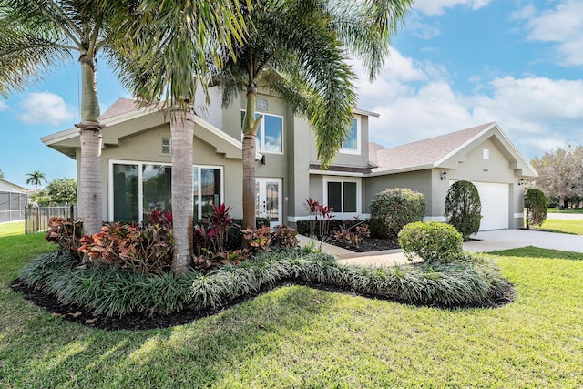 view of front facade with a garage and a front lawn