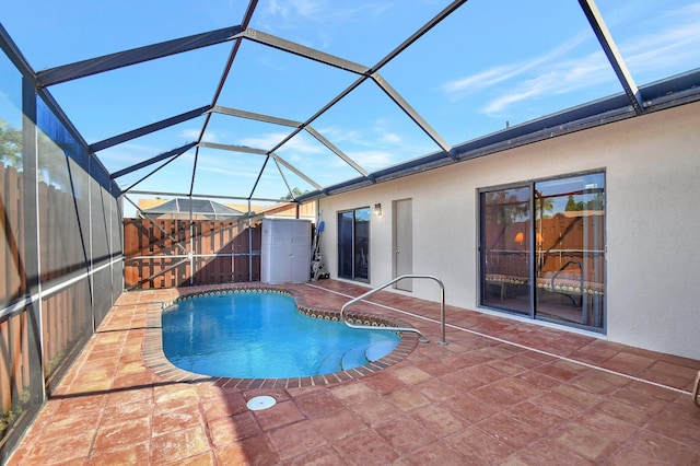 view of swimming pool with a lanai and a patio