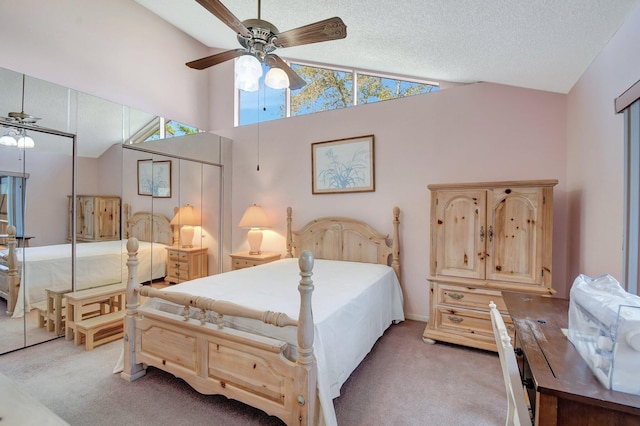 carpeted bedroom with high vaulted ceiling and a textured ceiling