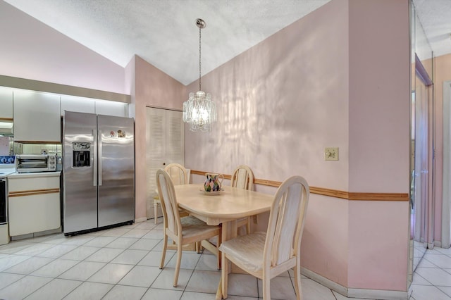 dining room featuring vaulted ceiling, light tile patterned flooring, a textured ceiling, and an inviting chandelier