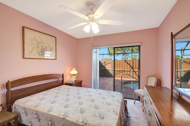 carpeted bedroom with ceiling fan, a textured ceiling, and access to outside